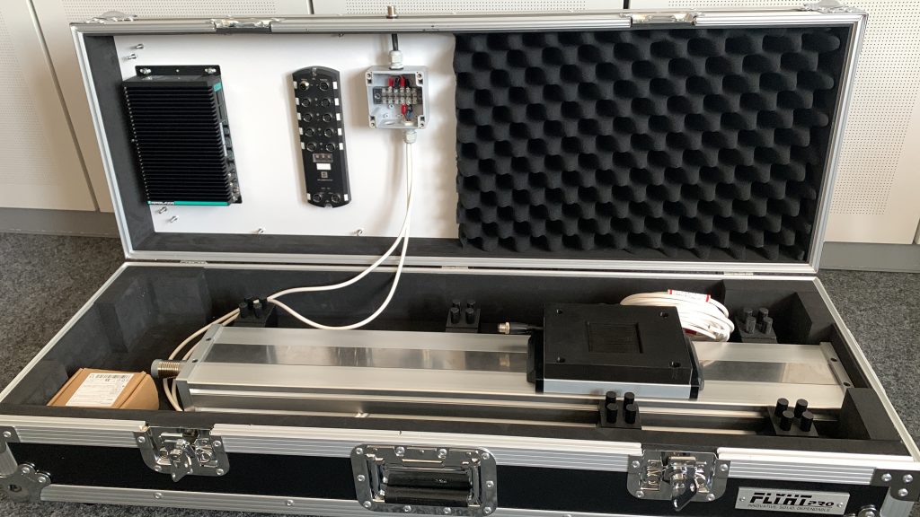 A look into the suitcase: The first installations have been made, you can see various technology, as well as the installed linear axis